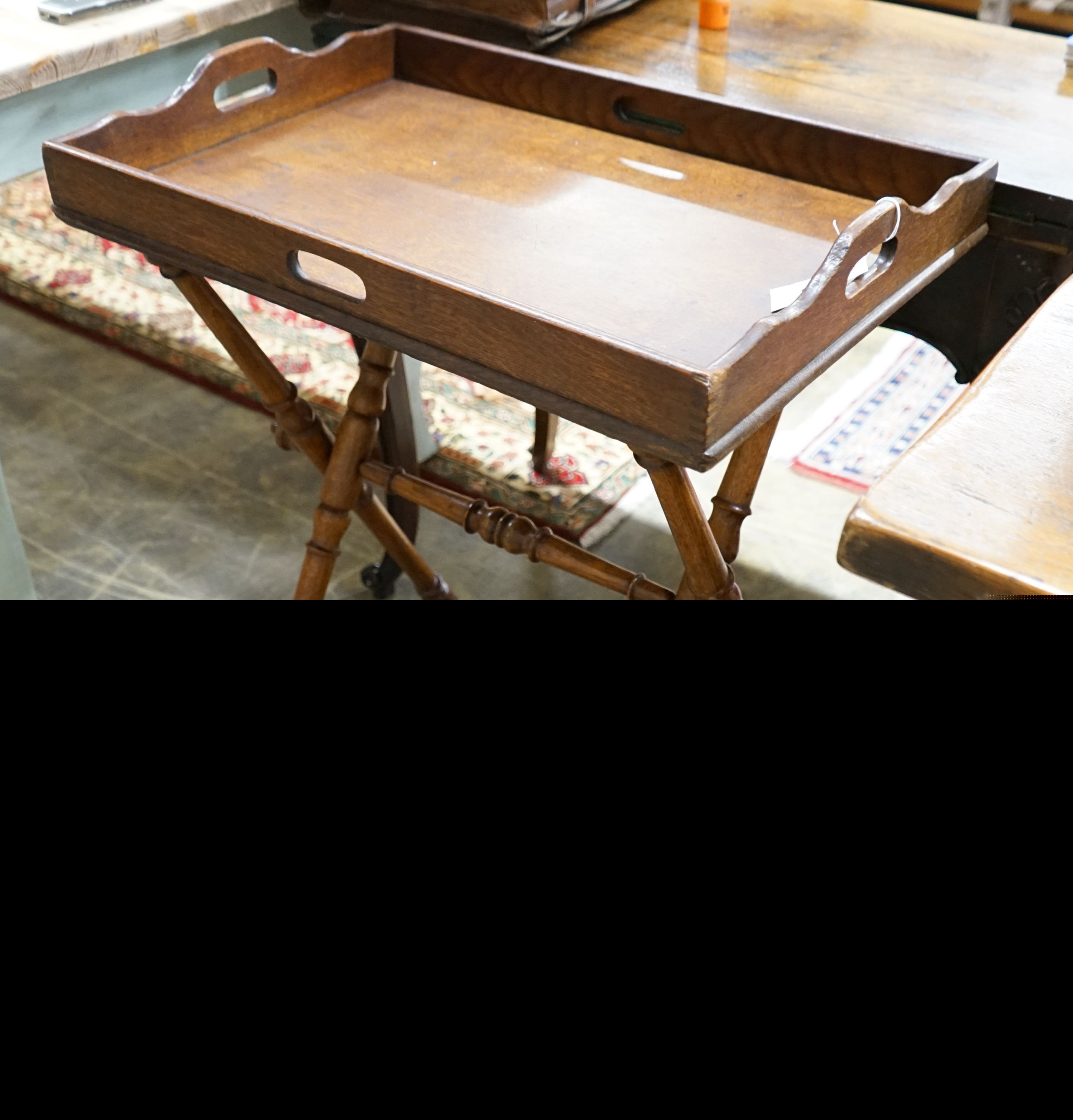 A late Victorian oak butler's tray on folding stand, width 62cm, depth 42cm, height 80cm
